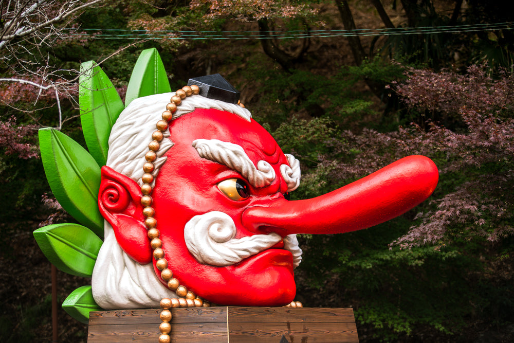 Big model of Tengu head stand in front of Kurama Station, Japan