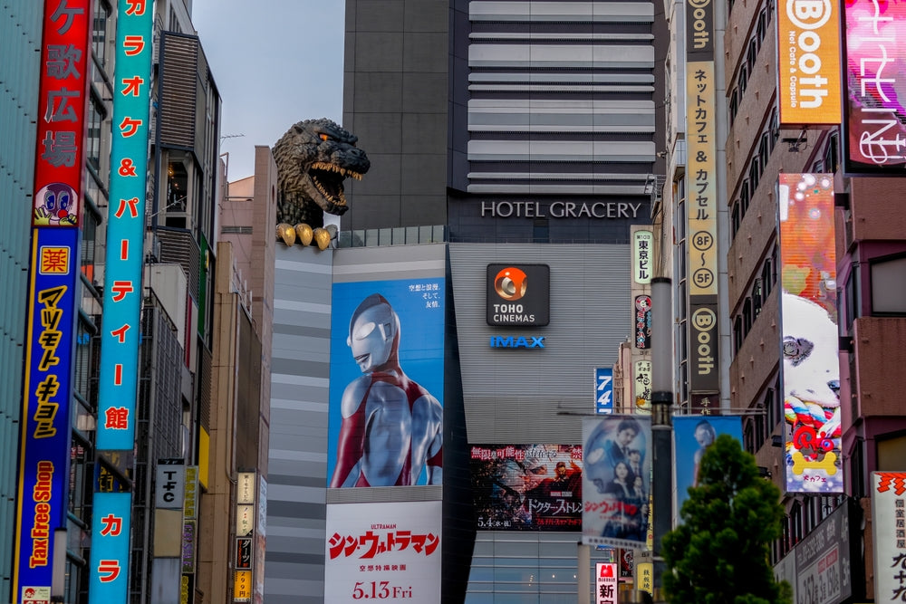 Godzilla and ads for "Shin Ultraman" and "Dr. Strange 2" at TOHO Cinema in Shinjuku.